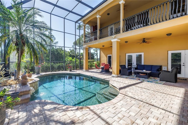 outdoor pool with a lanai, a ceiling fan, french doors, a patio area, and outdoor lounge area