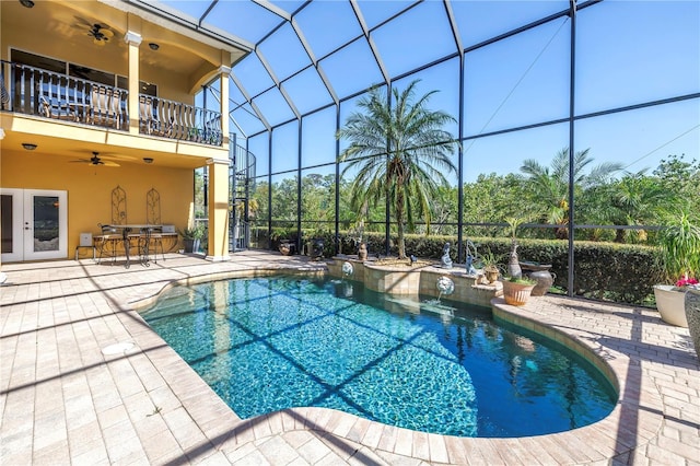 outdoor pool featuring a patio, french doors, outdoor dry bar, a ceiling fan, and glass enclosure