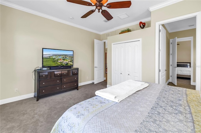 bedroom with a closet, ornamental molding, carpet, and baseboards
