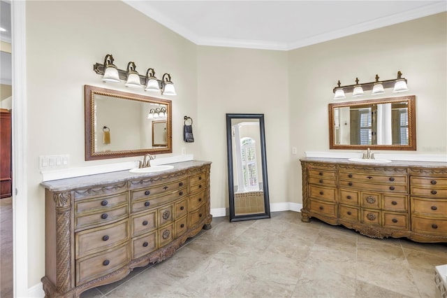 bathroom with baseboards, ornamental molding, and vanity