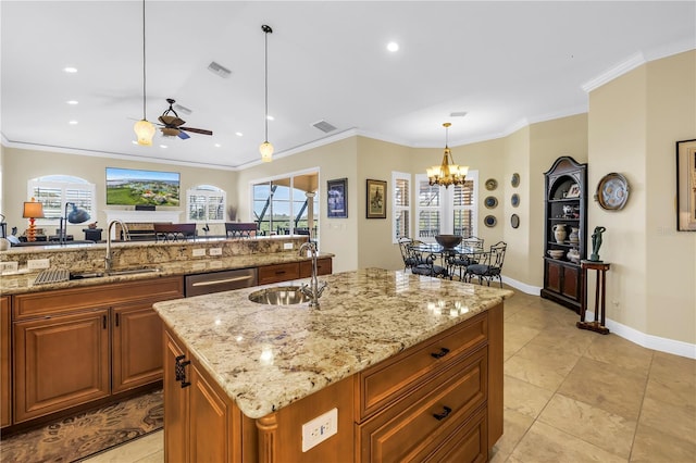 kitchen with a sink, crown molding, ceiling fan with notable chandelier, and visible vents