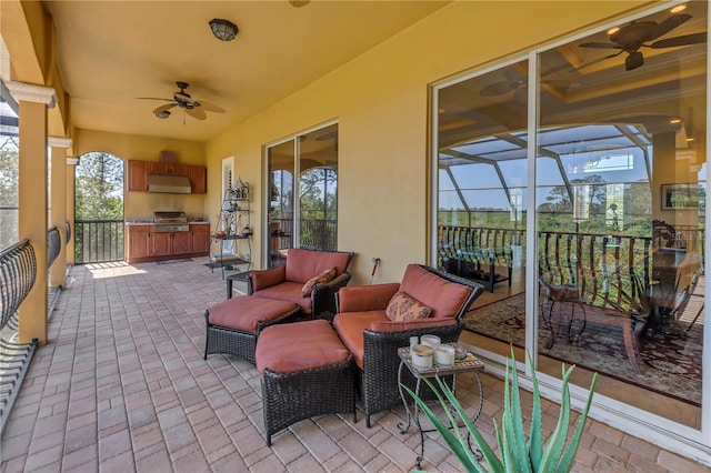 view of patio / terrace featuring area for grilling, an outdoor kitchen, outdoor lounge area, and a ceiling fan