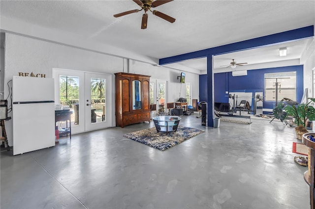 living area featuring ceiling fan, french doors, beam ceiling, and finished concrete flooring