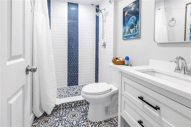 full bath with toilet, a tile shower, tile patterned flooring, and vanity