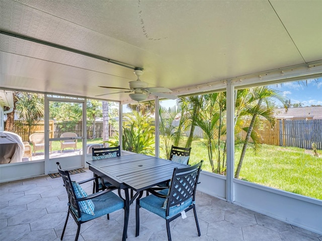 sunroom featuring a wealth of natural light, outdoor dining space, and ceiling fan