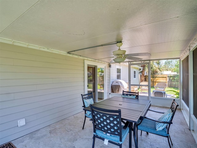 view of patio / terrace featuring ceiling fan, fence, and outdoor dining space