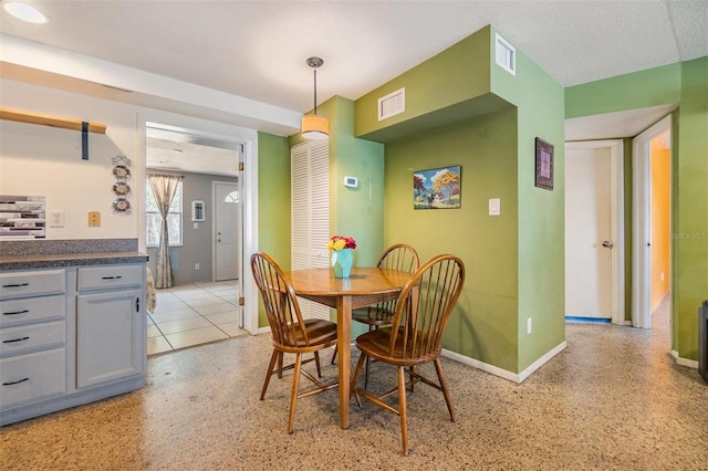 dining space with baseboards and visible vents