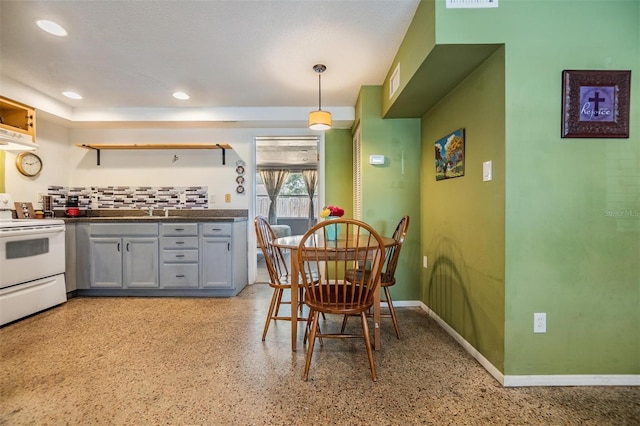 kitchen with gray cabinets, dark countertops, open shelves, white range with electric stovetop, and under cabinet range hood