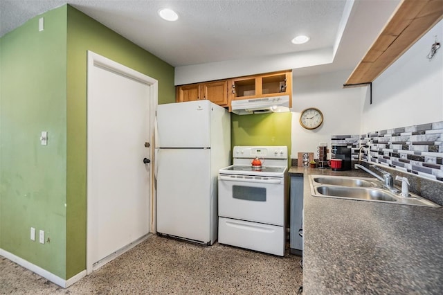 kitchen featuring brown cabinets, a sink, under cabinet range hood, recessed lighting, and white appliances