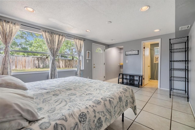 bedroom featuring recessed lighting, a textured ceiling, and light tile patterned floors