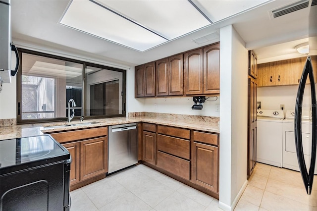 4002 Cypress Ct Unit 4002, Tampa, FL 33618 - kitchen with washing machine and clothes dryer, electric range, a sink, dishwasher, and light tile patterned floors