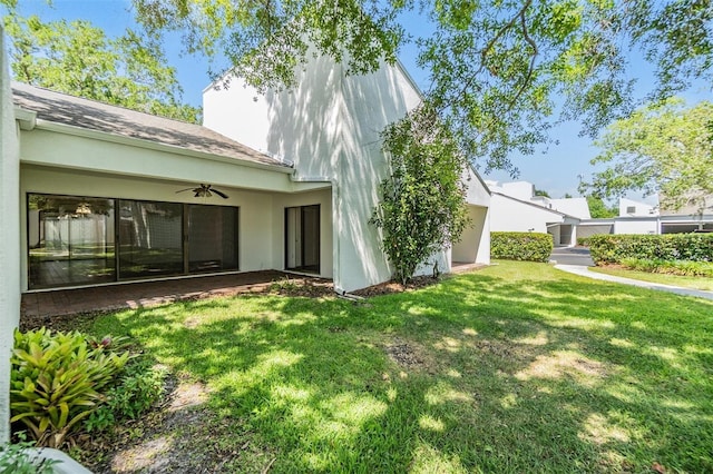 4002 Cypress Ct Unit 4002, Tampa, FL 33618 - rear view of house with a lawn, ceiling fan, and stucco siding