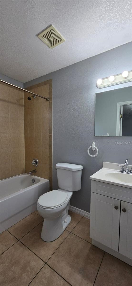 bathroom featuring visible vents, tile patterned flooring, vanity, toilet, and a textured ceiling