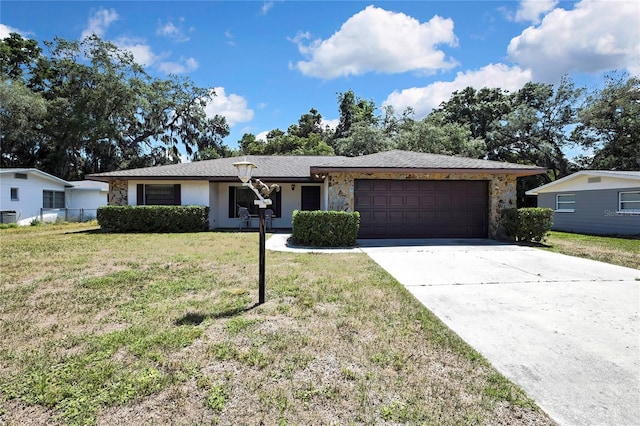 883 N Hollywood Cir, Crystal River, FL 34429 - single story home with stone siding, a garage, a front yard, central AC unit, and concrete driveway
