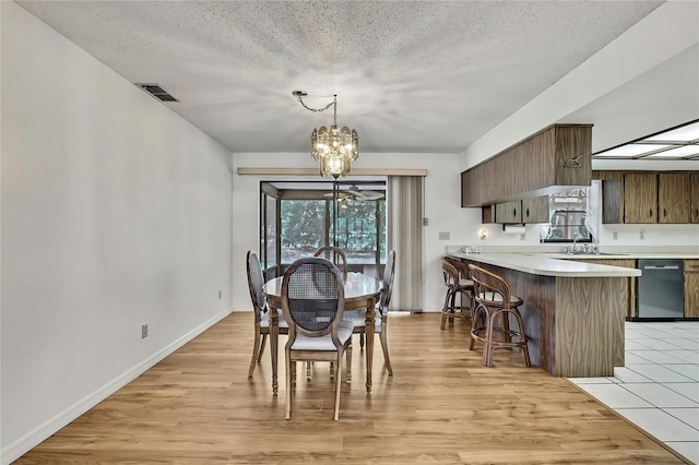 883 N Hollywood Cir, Crystal River, FL 34429 - dining area with a textured ceiling, a notable chandelier, visible vents, and light wood-type flooring