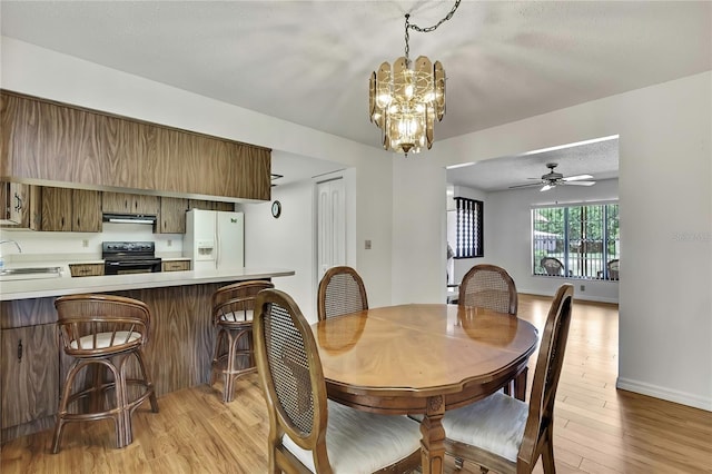 883 N Hollywood Cir, Crystal River, FL 34429 - dining space featuring baseboards, ceiling fan with notable chandelier, and light wood-style floors