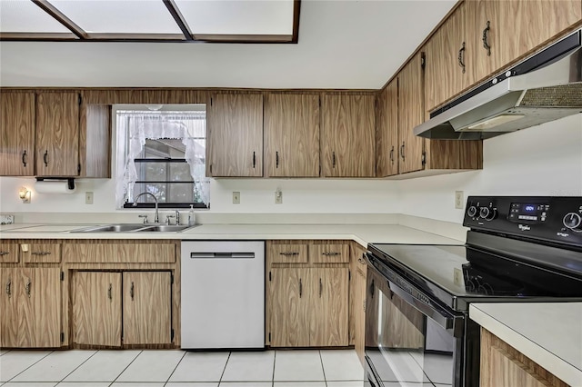 883 N Hollywood Cir, Crystal River, FL 34429 - kitchen featuring electric range, light tile patterned floors, under cabinet range hood, a sink, and dishwasher