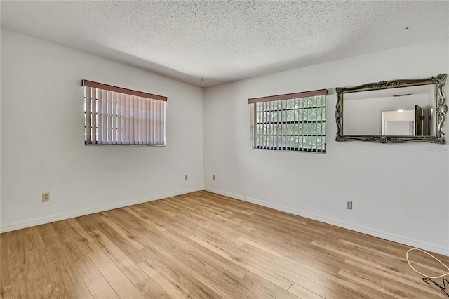 883 N Hollywood Cir, Crystal River, FL 34429 - spare room with a textured ceiling, baseboards, and wood finished floors
