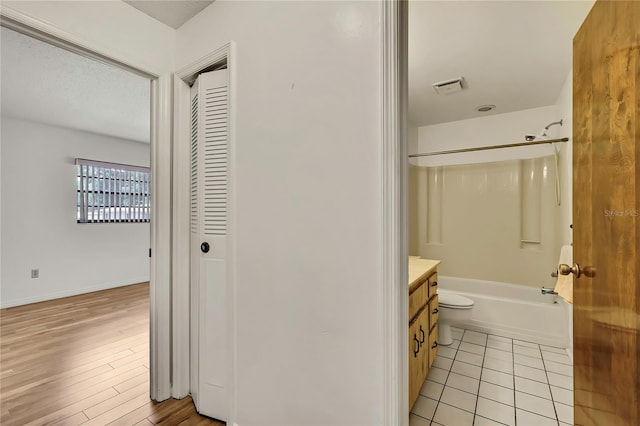 883 N Hollywood Cir, Crystal River, FL 34429 - full bathroom featuring visible vents, vanity, wood finished floors, tub / shower combination, and toilet