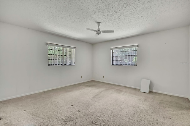 883 N Hollywood Cir, Crystal River, FL 34429 - spare room with carpet floors, ceiling fan, a textured ceiling, and a wealth of natural light