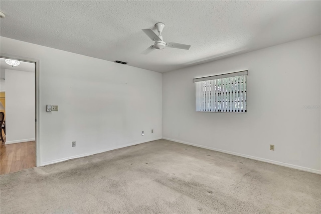 883 N Hollywood Cir, Crystal River, FL 34429 - spare room featuring baseboards, carpet flooring, a textured ceiling, and ceiling fan