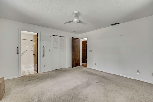 883 N Hollywood Cir, Crystal River, FL 34429 - unfurnished bedroom featuring ceiling fan, visible vents, baseboards, carpet flooring, and ensuite bath