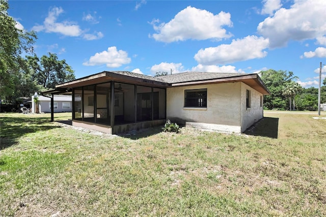 883 N Hollywood Cir, Crystal River, FL 34429 - back of property featuring a yard, a sunroom, and stucco siding