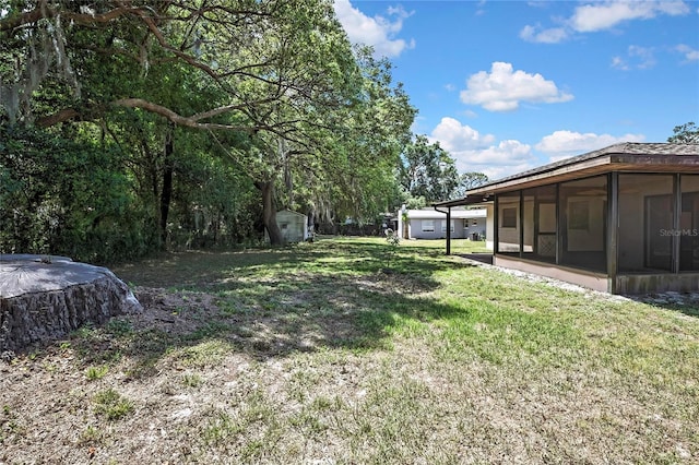883 N Hollywood Cir, Crystal River, FL 34429 - view of yard with a sunroom, an outdoor structure, and a shed