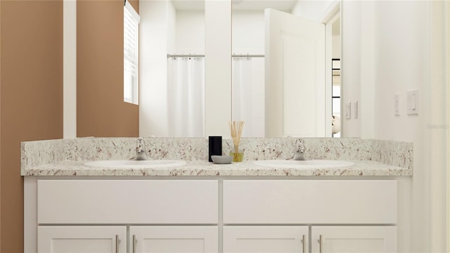 bathroom with a sink and double vanity