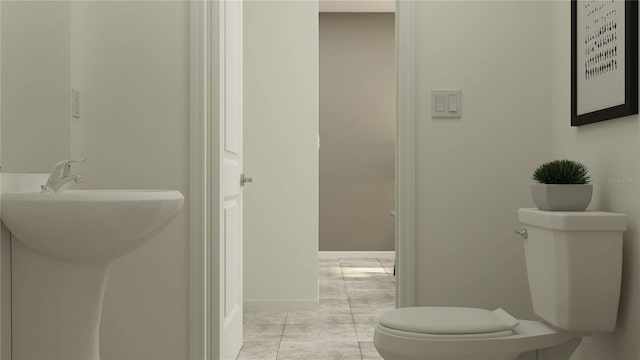 bathroom featuring baseboards, a sink, and toilet