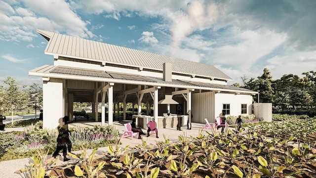 rear view of house featuring a patio and metal roof