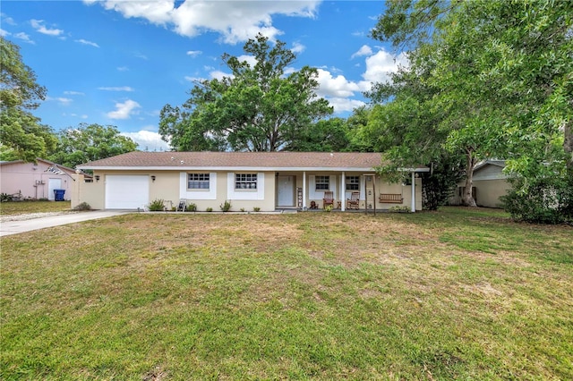 single story home with a front lawn, a garage, stucco siding, a porch, and concrete driveway