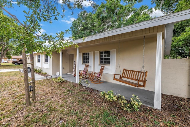 view of front of home with stucco siding and covered porch
