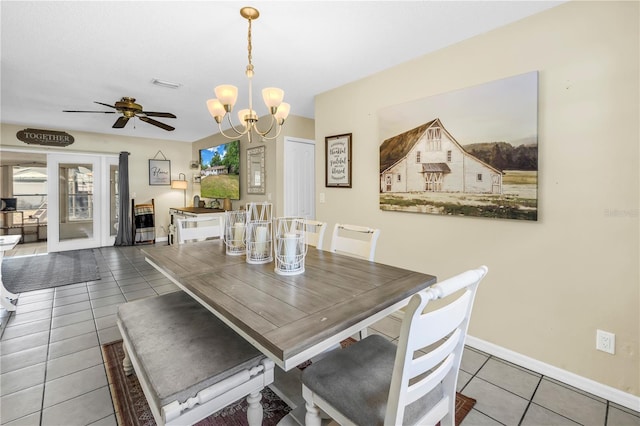 dining space with tile patterned flooring, visible vents, baseboards, french doors, and ceiling fan with notable chandelier
