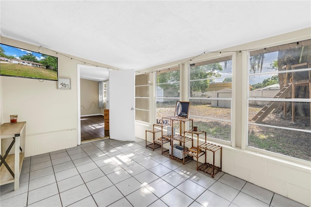 sunroom / solarium featuring a healthy amount of sunlight