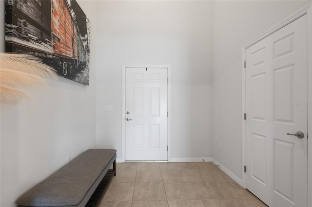 interior space featuring baseboards and light tile patterned floors