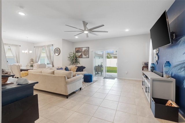 living room featuring plenty of natural light, recessed lighting, and ceiling fan with notable chandelier