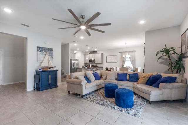 living room featuring visible vents, recessed lighting, ceiling fan with notable chandelier, stairs, and light tile patterned flooring