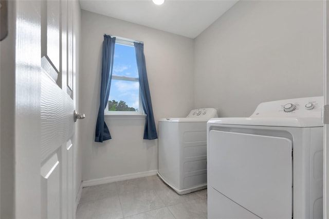 laundry room featuring baseboards, laundry area, and washer and clothes dryer