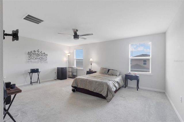 bedroom with a ceiling fan, baseboards, visible vents, and carpet