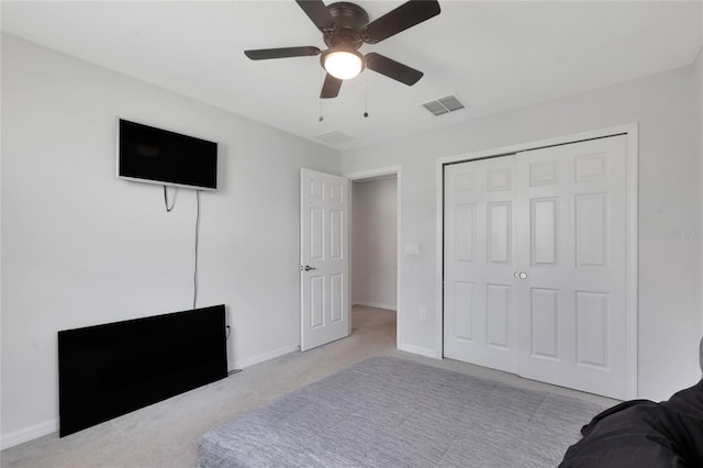 carpeted bedroom with visible vents, baseboards, ceiling fan, and a closet