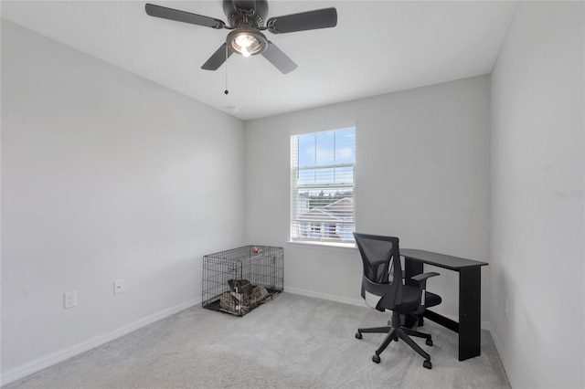 unfurnished office featuring carpet flooring, baseboards, and ceiling fan
