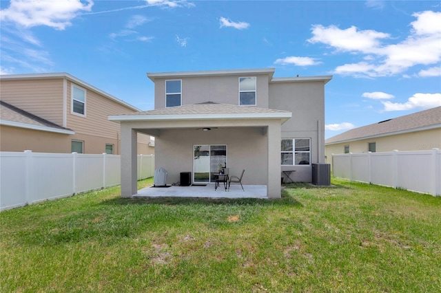 back of property featuring a lawn, a patio, stucco siding, and central air condition unit