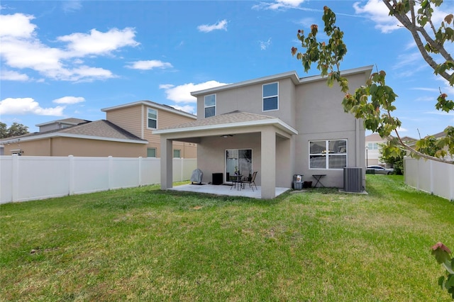 back of house with a lawn, a patio, central AC, and stucco siding