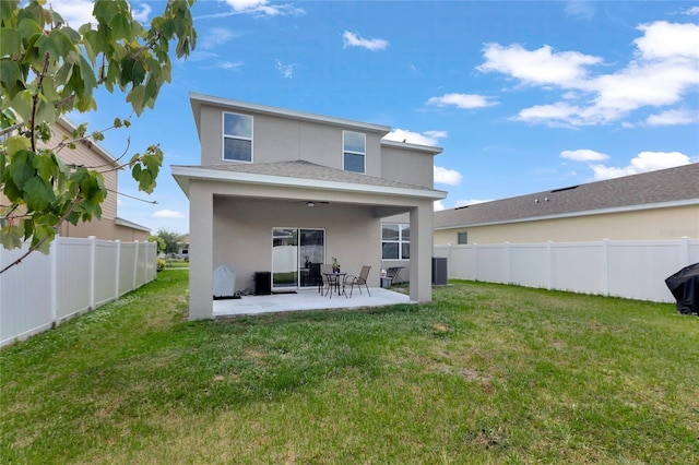 back of house with a patio, a fenced backyard, stucco siding, and a yard