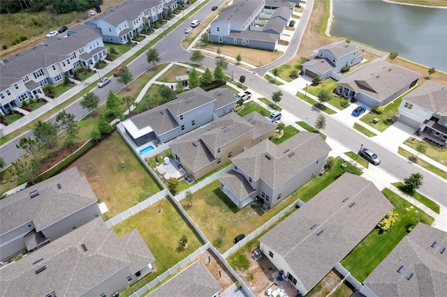 birds eye view of property featuring a water view and a residential view