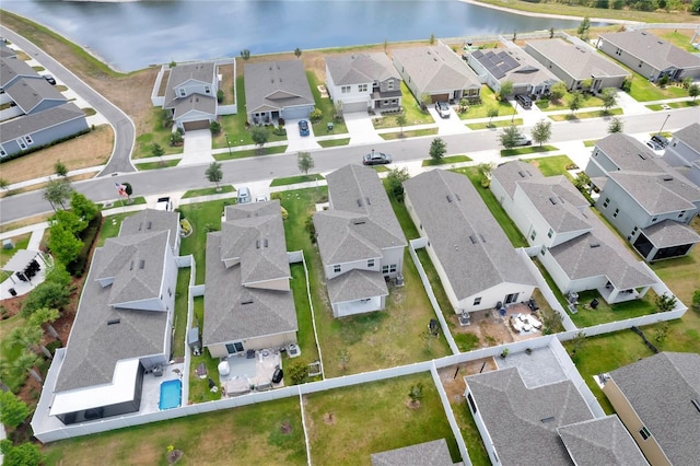 bird's eye view with a water view and a residential view