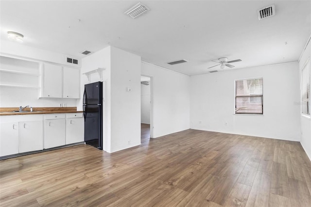 536 Braddock St S, Saint Petersburg, FL 33707 - kitchen featuring visible vents, freestanding refrigerator, white cabinetry, and butcher block counters