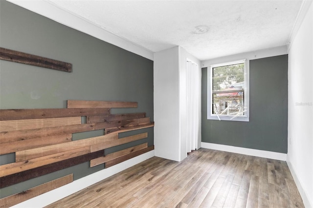 536 Braddock St S, Saint Petersburg, FL 33707 - unfurnished room featuring baseboards, a textured ceiling, and wood finished floors