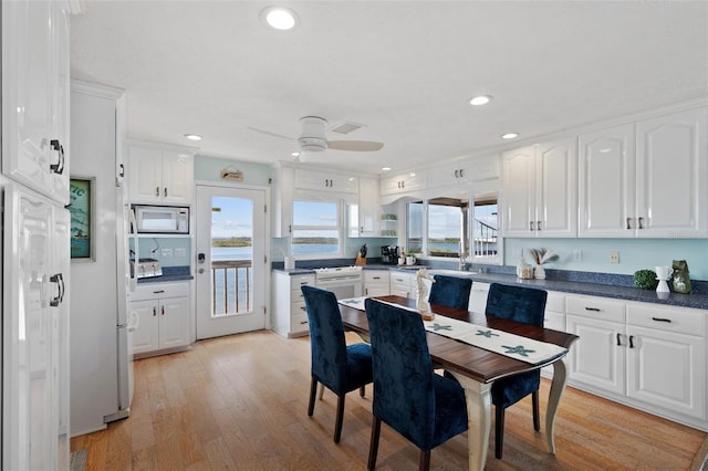 kitchen with recessed lighting, white cabinets, white appliances, and light wood-style flooring